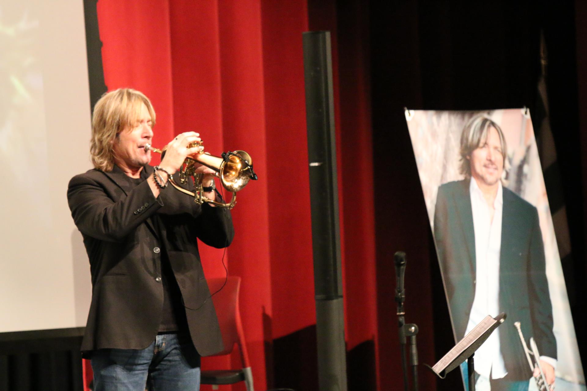 David Wells plays a tune as a part of his motivational assembly for students