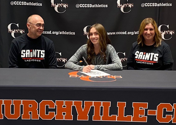 Churchville-Chili senior Madison Buck celebrates her future with the D’Youville Saints lacrosse team with her parents John and Melissa Buck. 