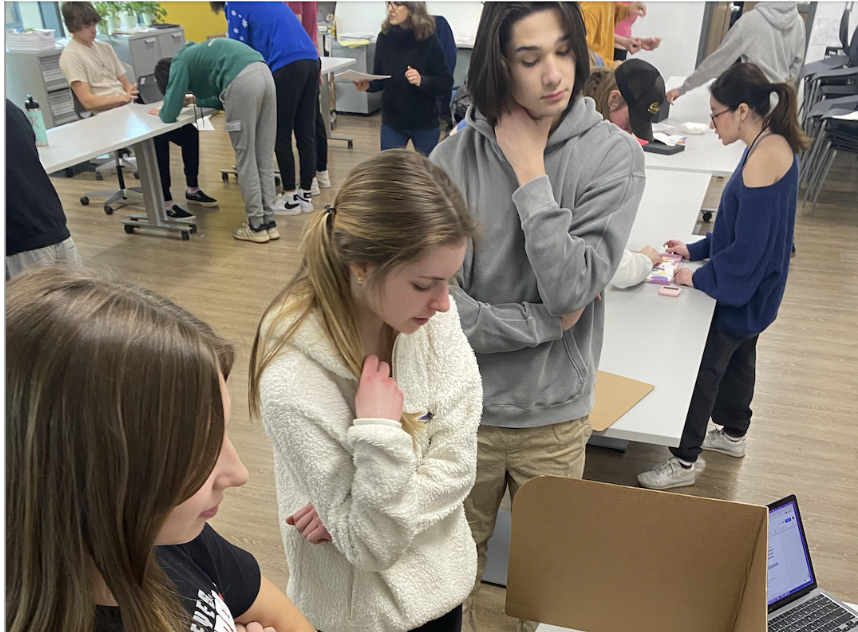 Students interacting with an exhibit during their exam