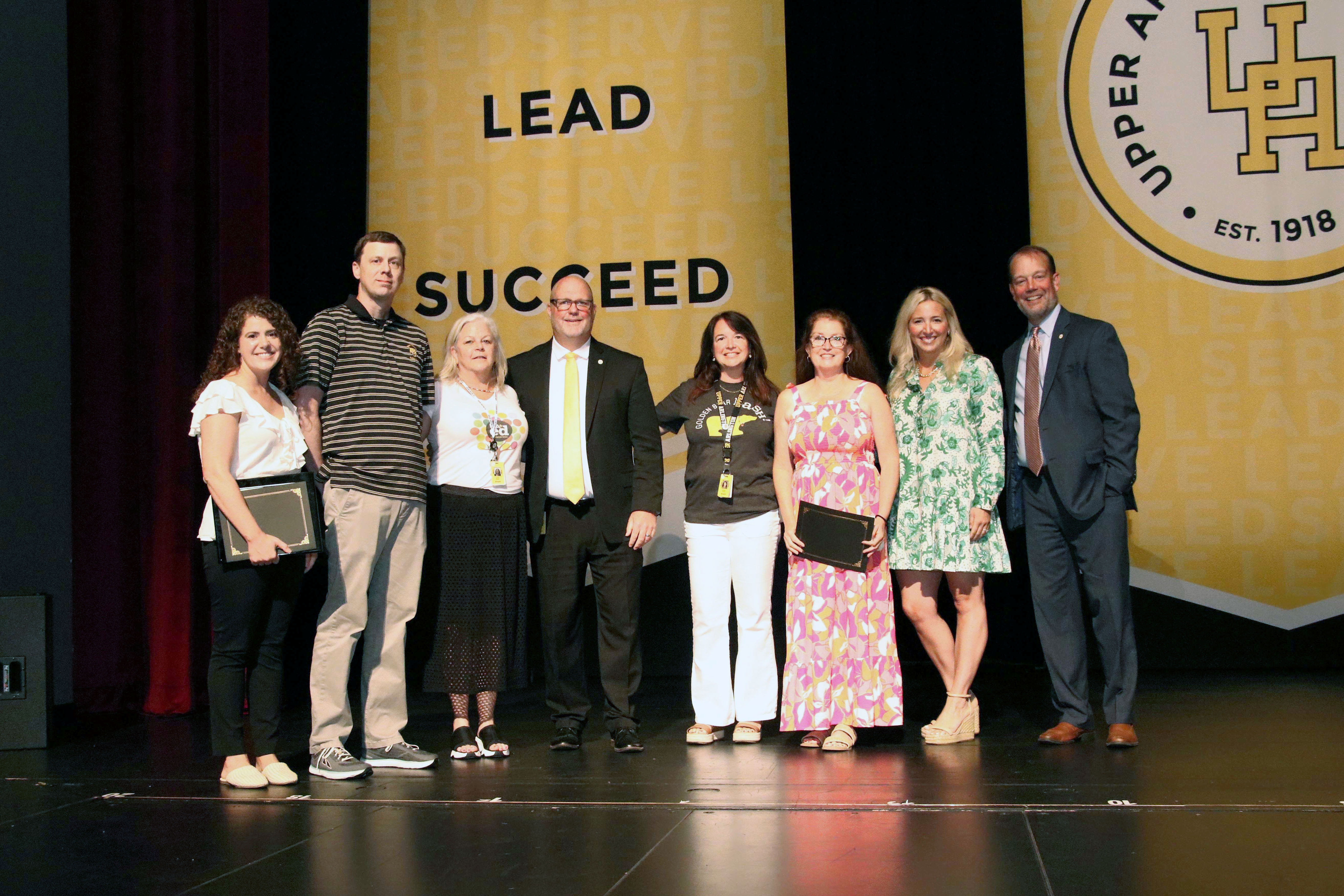 The three recipients of the Joanie Dugger Educator of the Year Awards posing for a photo with administrators and representatives from the Upper Arlington Education Foundation